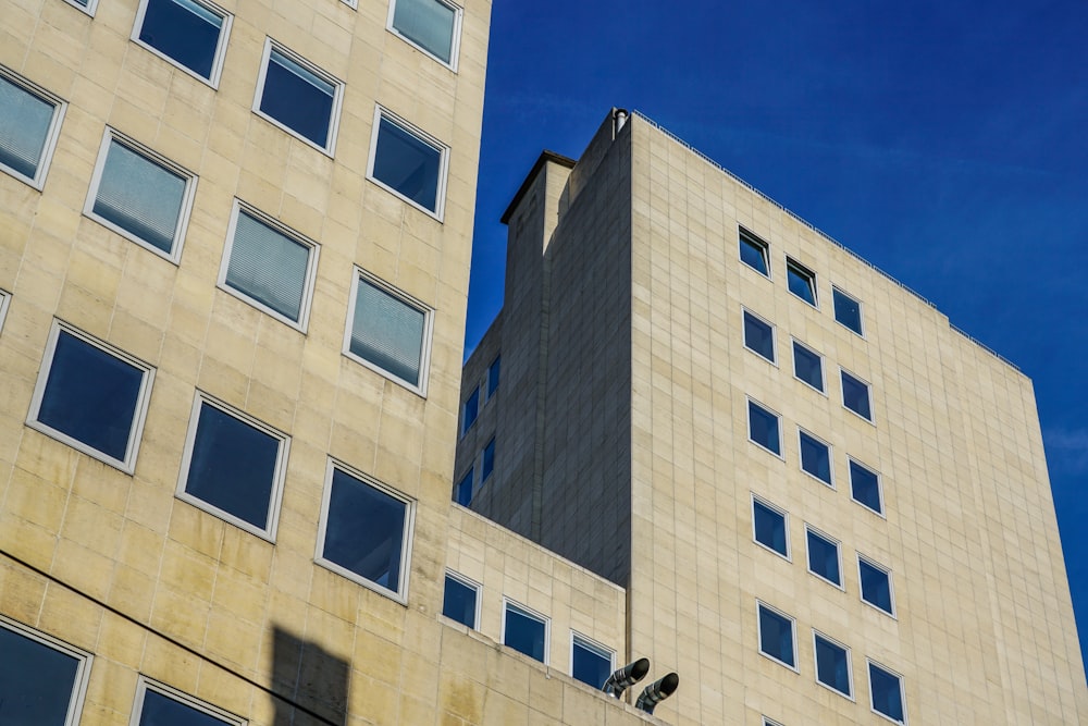 a tall building with windows and a sky background