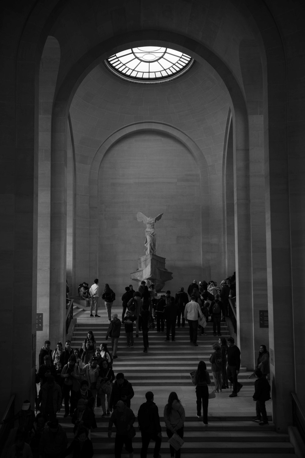 a black and white photo of people in a building