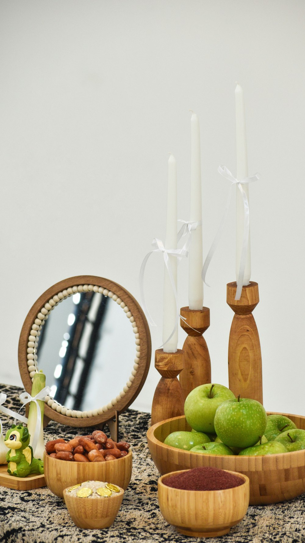 a table topped with bowls of fruit and candles