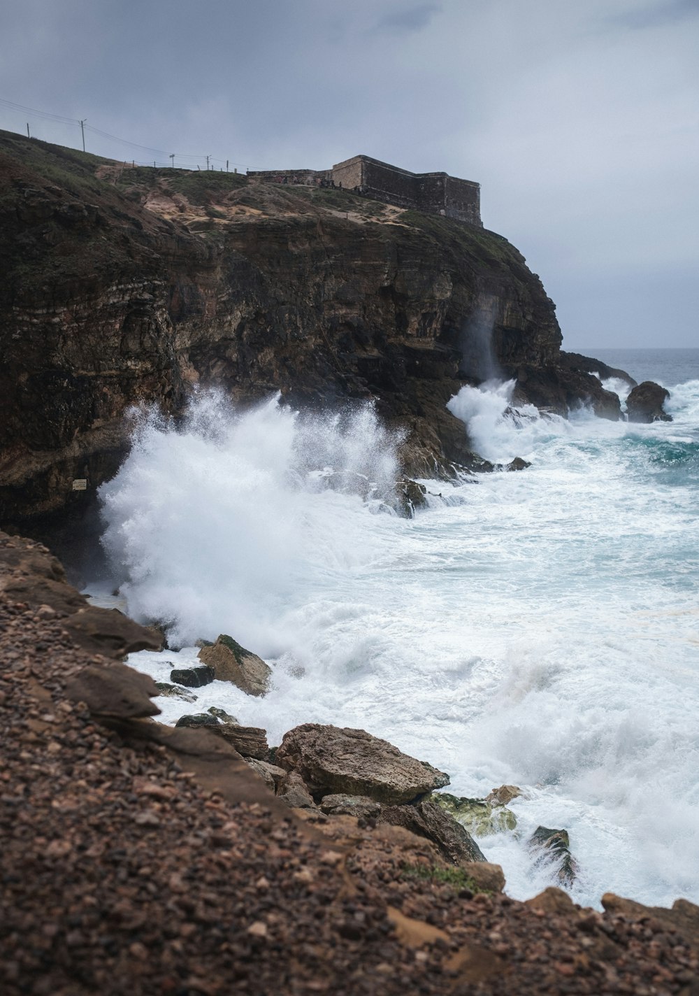 a rocky shore with waves crashing against the rocks