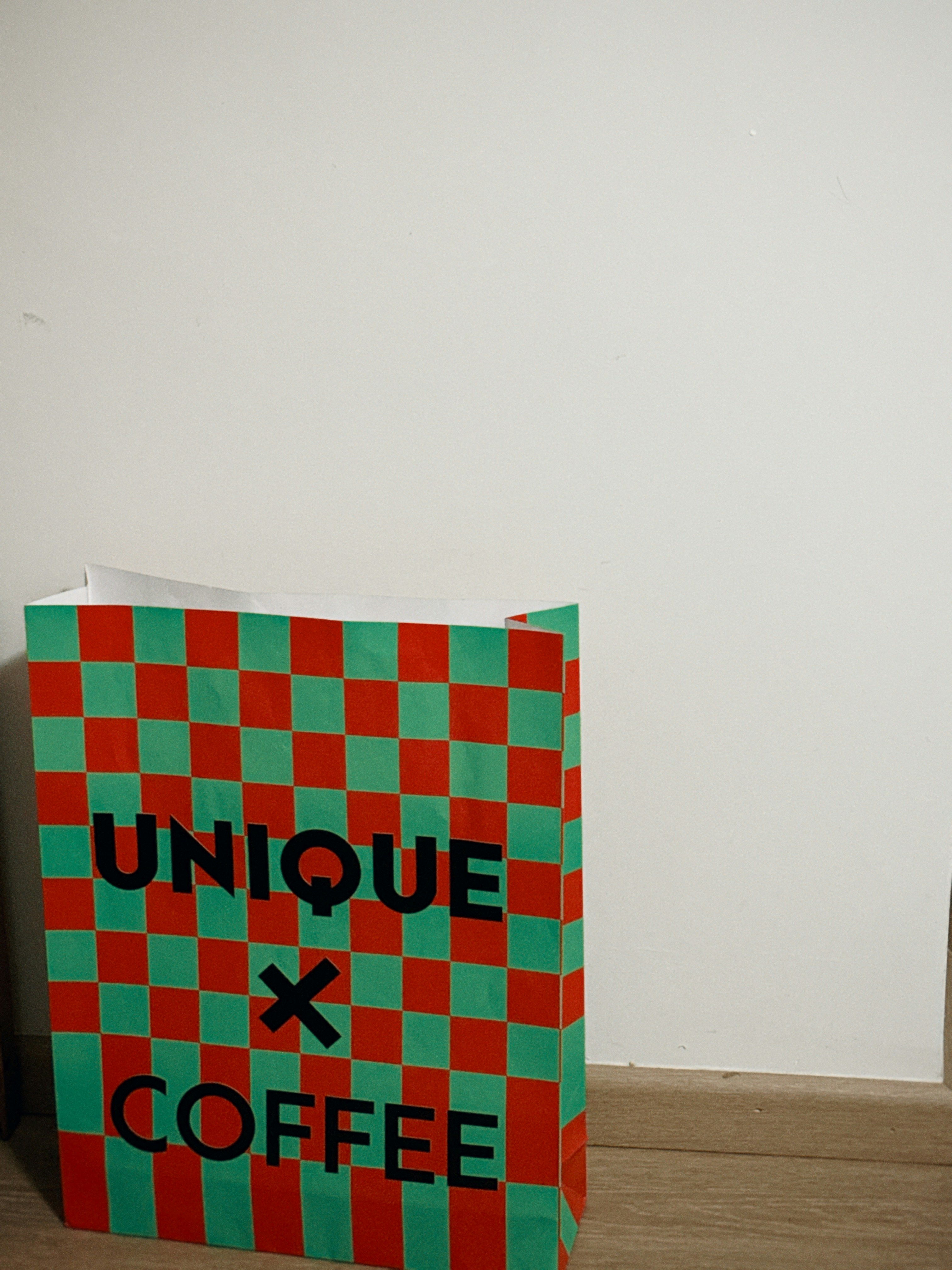 A paper bag sitting on top of a wooden floor photo – Free Book Image on ...