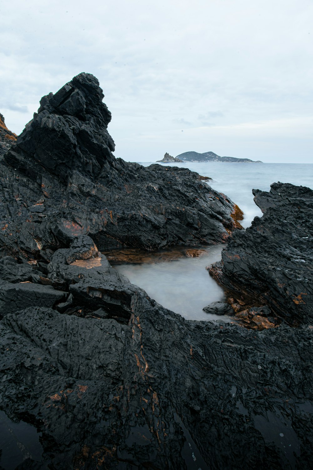 a rocky beach with a small body of water