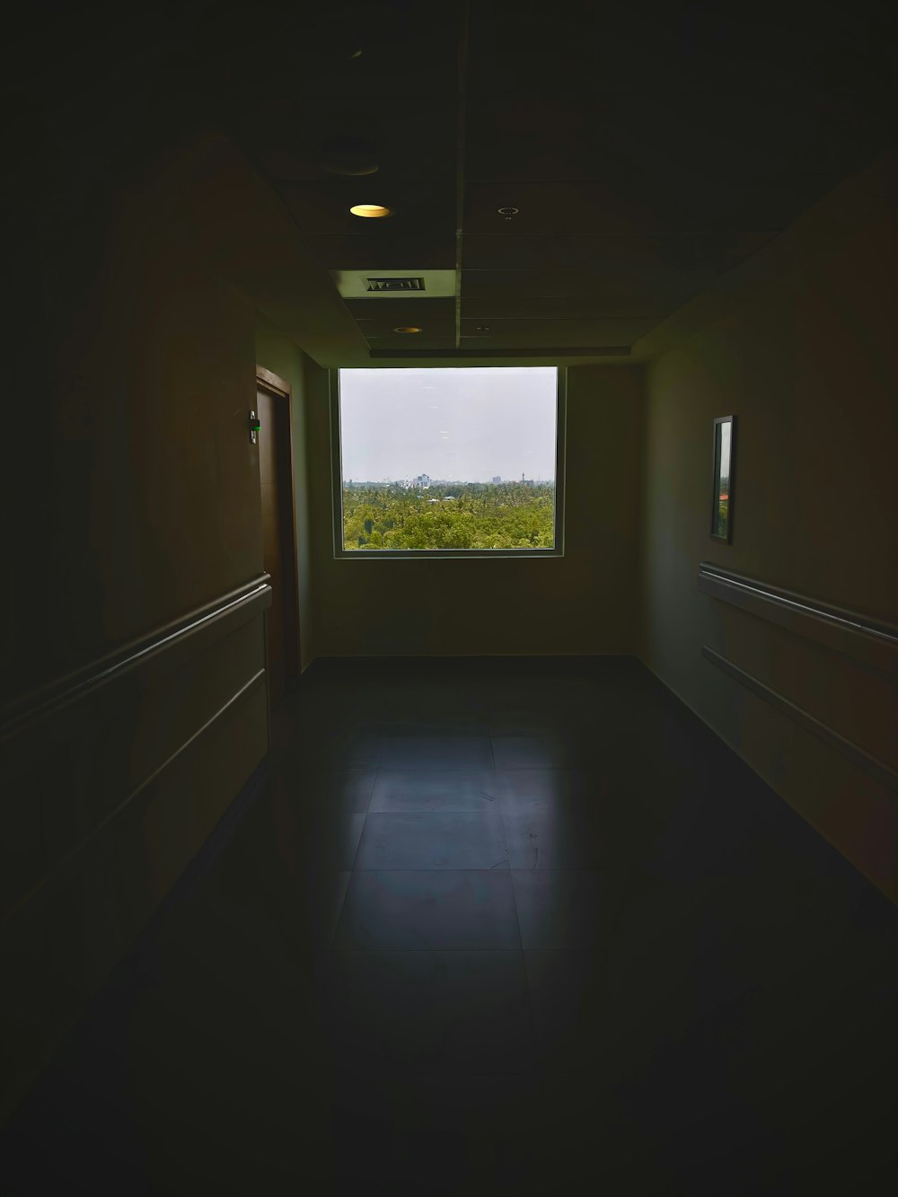 a dimly lit room with a large window