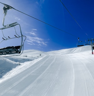 a ski lift going up a snowy hill