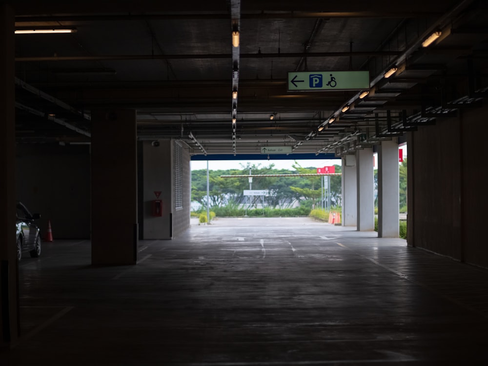 an empty parking garage with a car parked in it