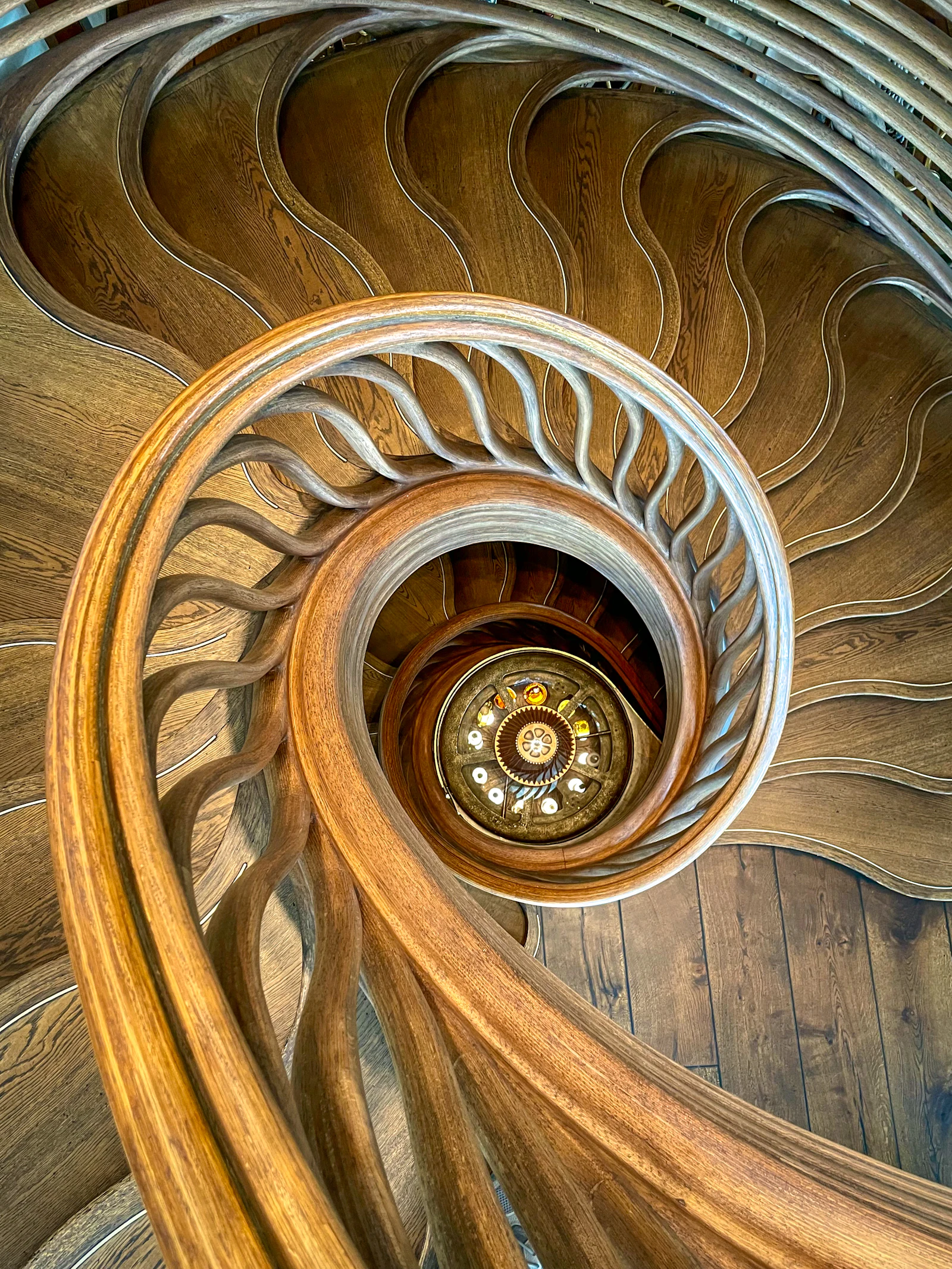 A spiral wooden staircase in a building