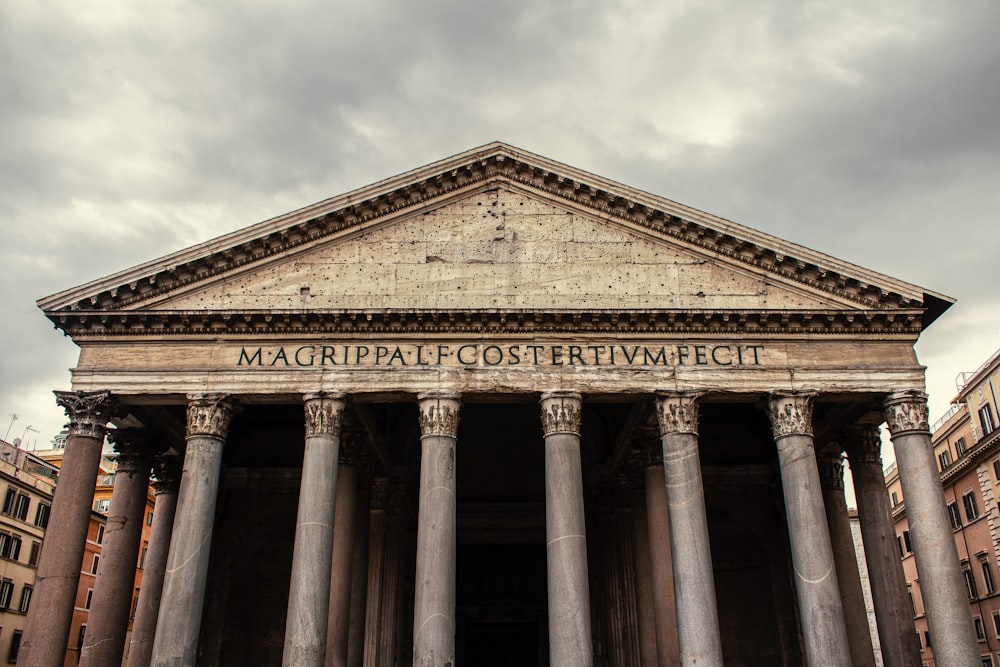 a large building with columns and a sign on it