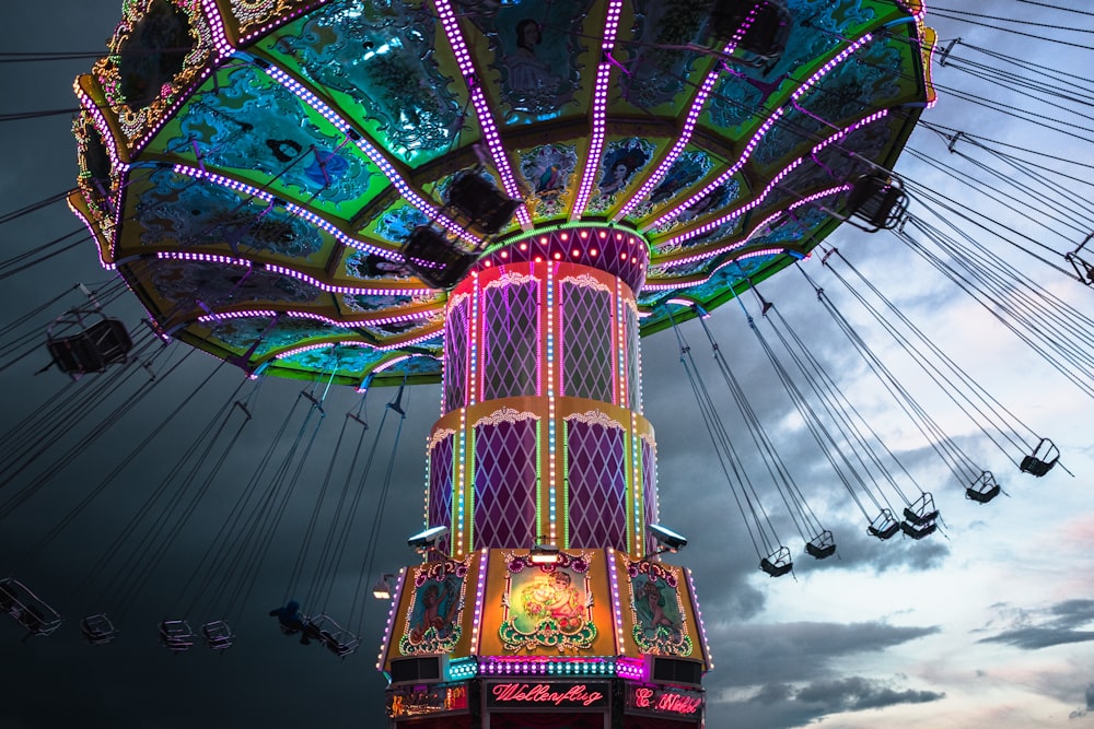 a brightly lit carnival ride at a carnival