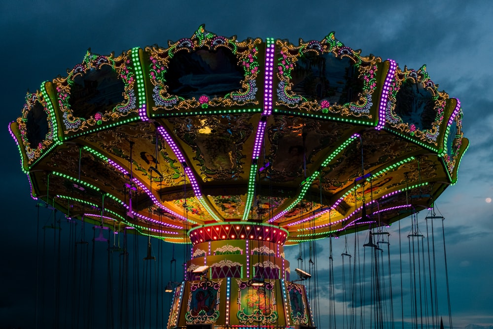 a brightly lit merry go round at night