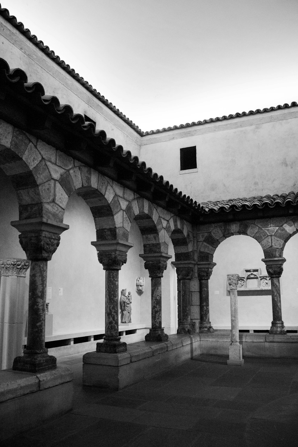 a black and white photo of a building with arches