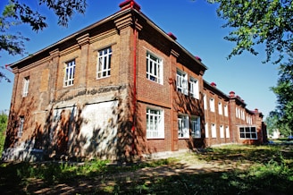 an old brick building with a red roof
