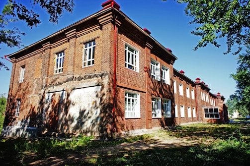 an old brick building with a red roof