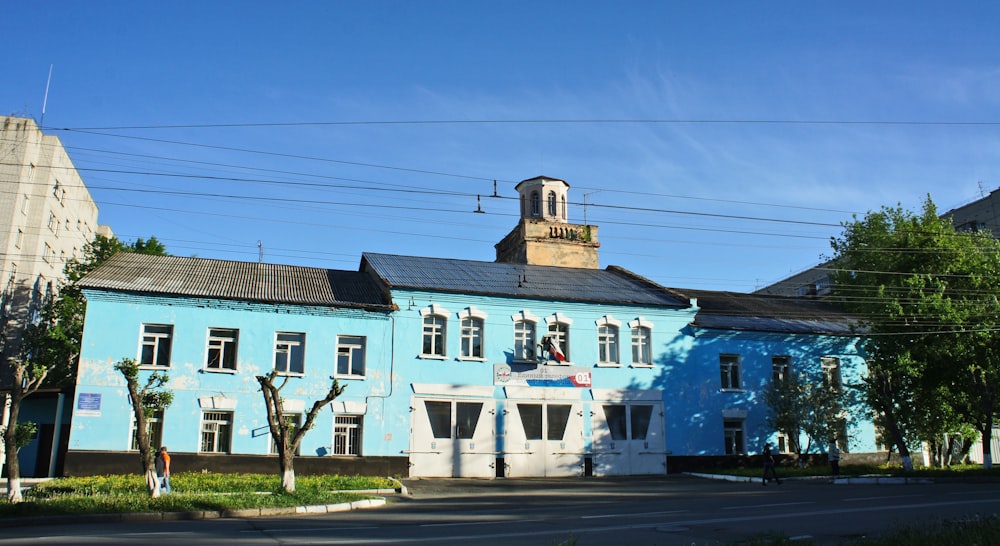 a blue building with a clock tower on top of it