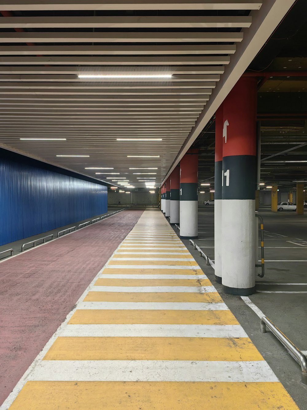 an empty parking garage with yellow and white stripes