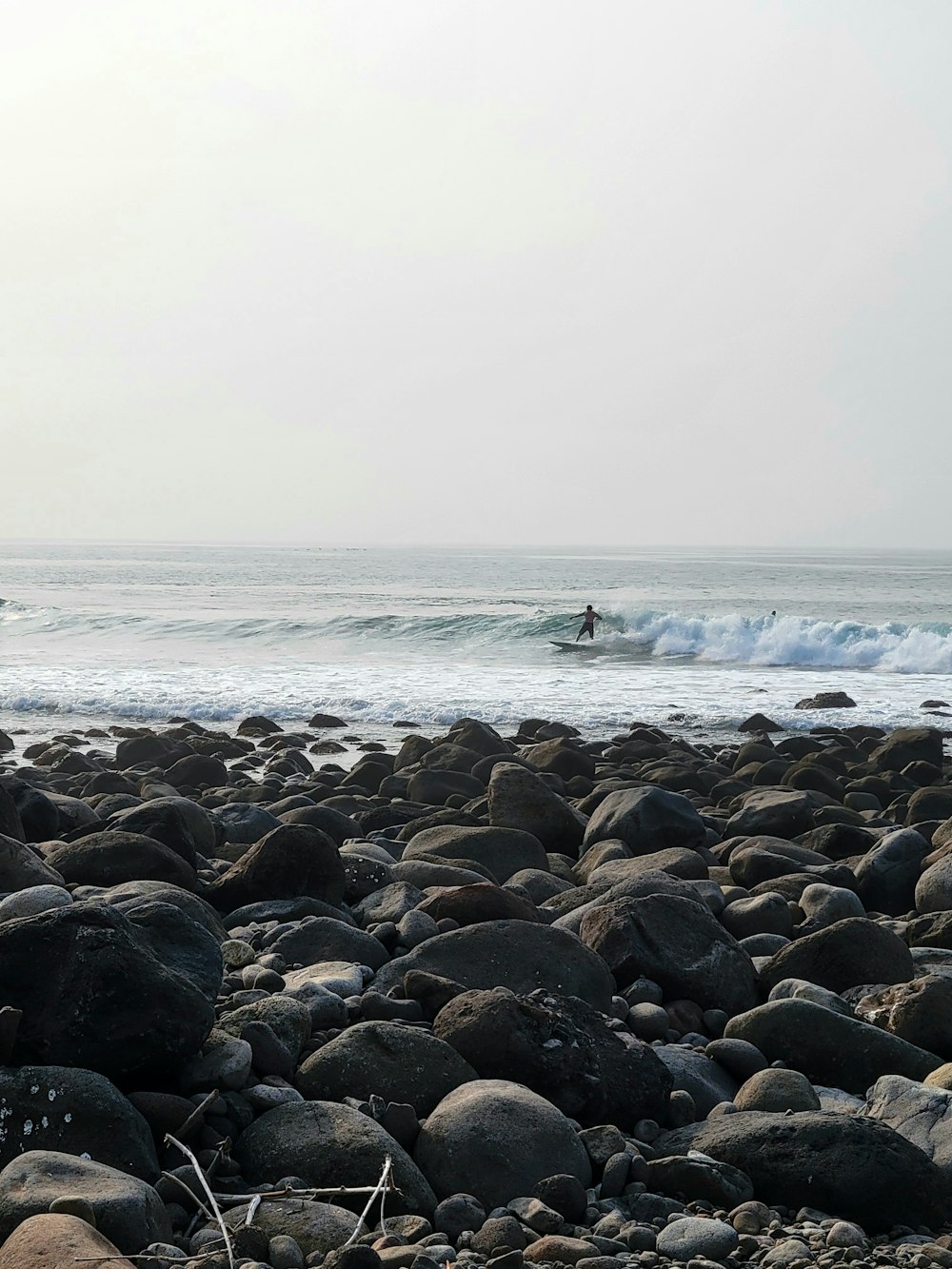 a person riding a surfboard on a wave in the ocean