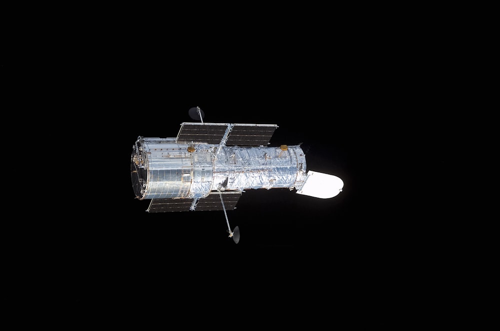 a satellite in the dark with a black background