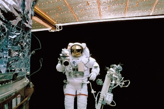 a man in a space suit standing next to a space station