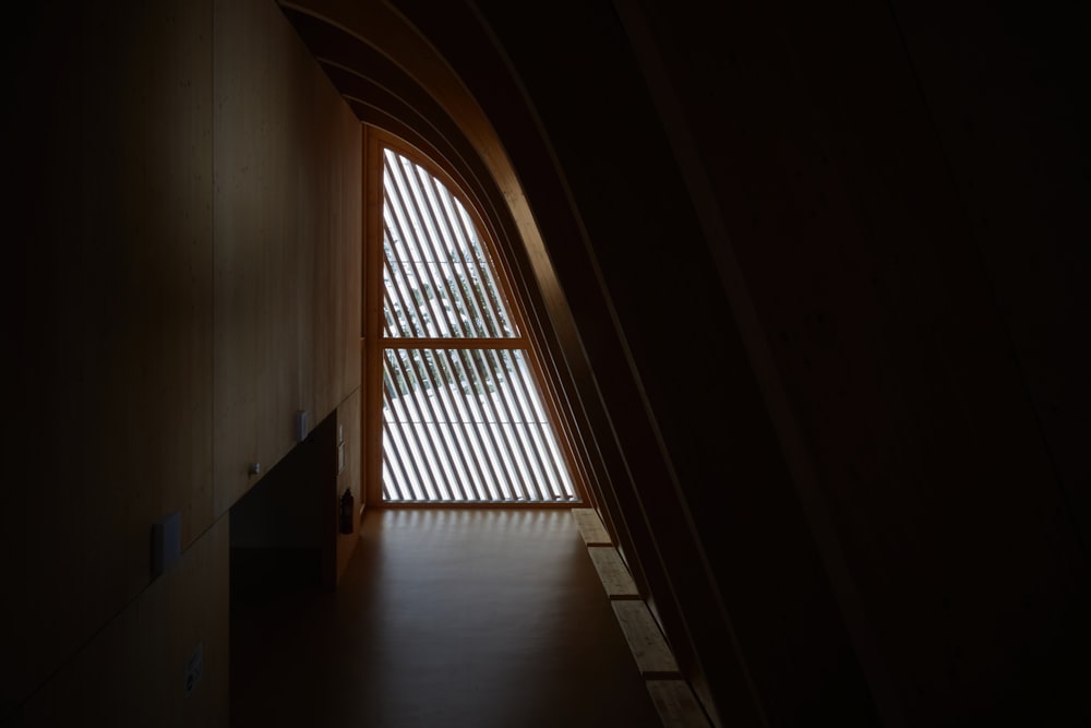 a room with a large window and a staircase