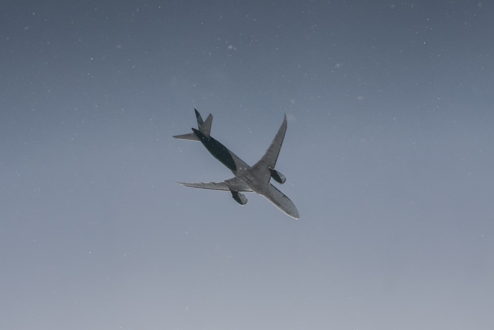 a large jetliner flying through a blue sky