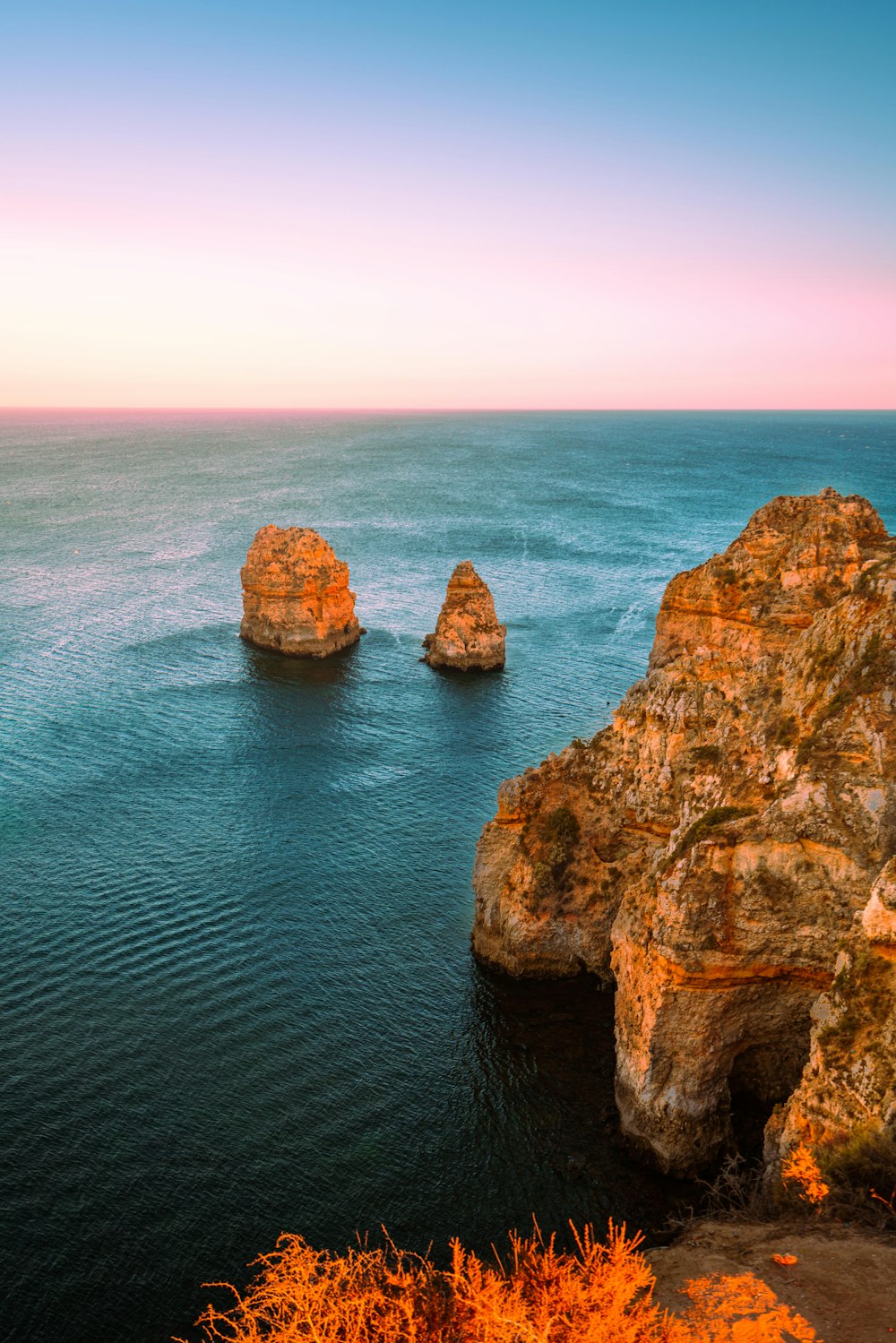 a body of water with some rocks in the middle of it