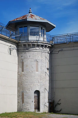 a tall white tower with a clock on it's side