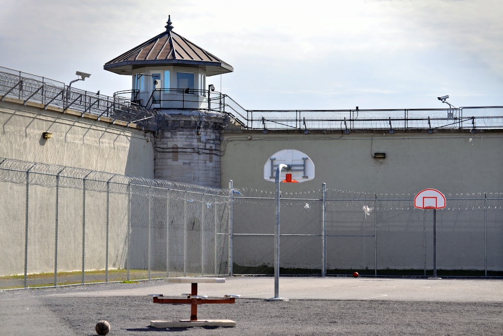 a basketball court in front of a jail cell
