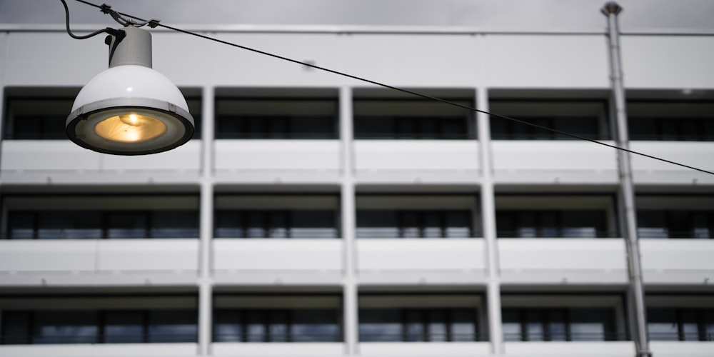 a street light hanging from a wire in front of a building