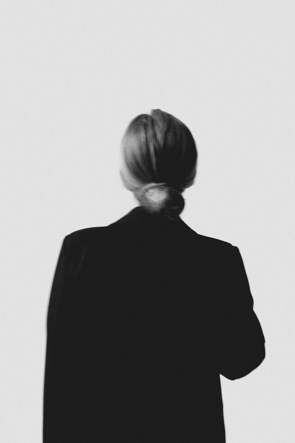 a black and white photo of a woman's back