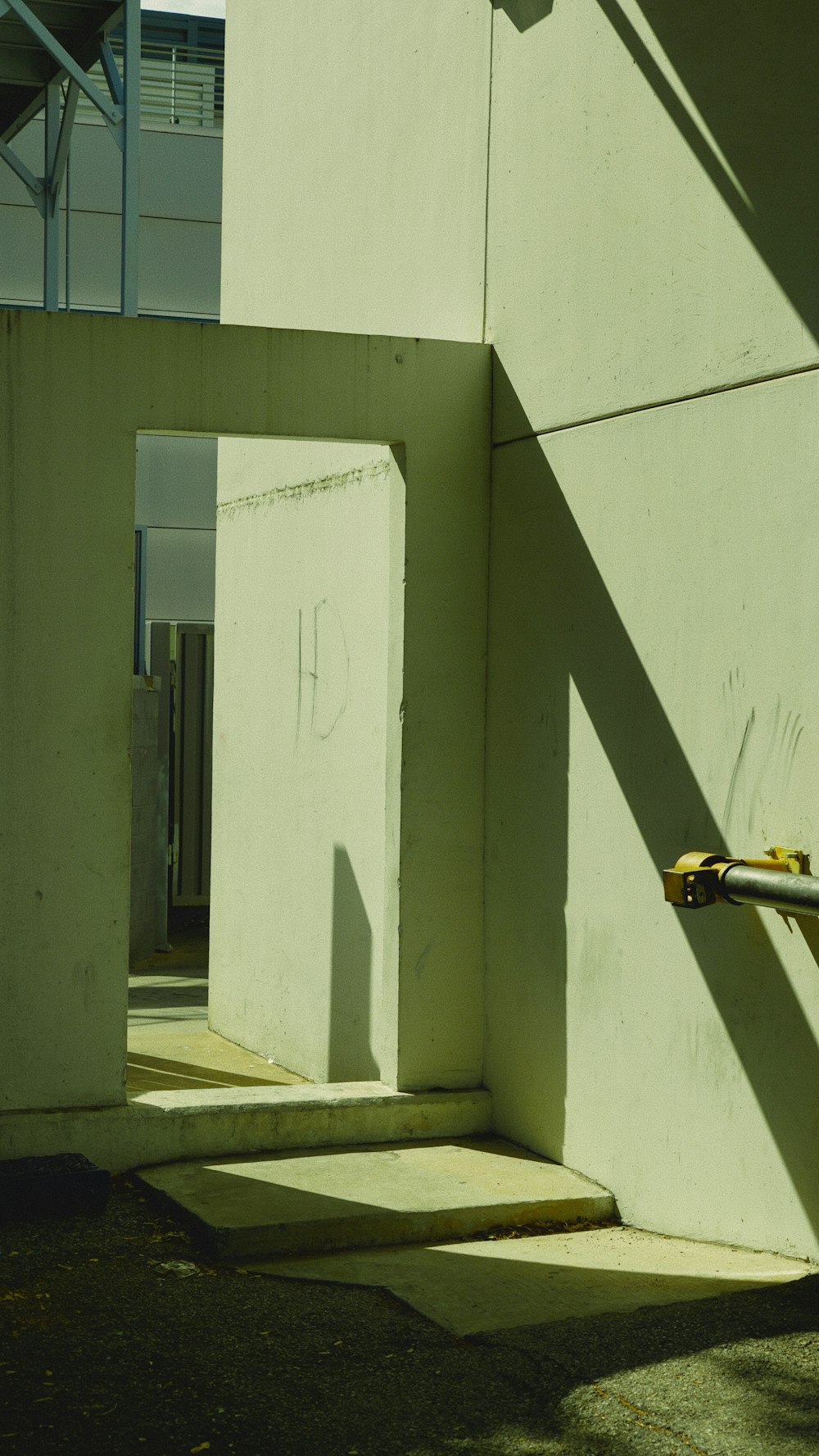 a yellow fire hydrant sitting next to a white building