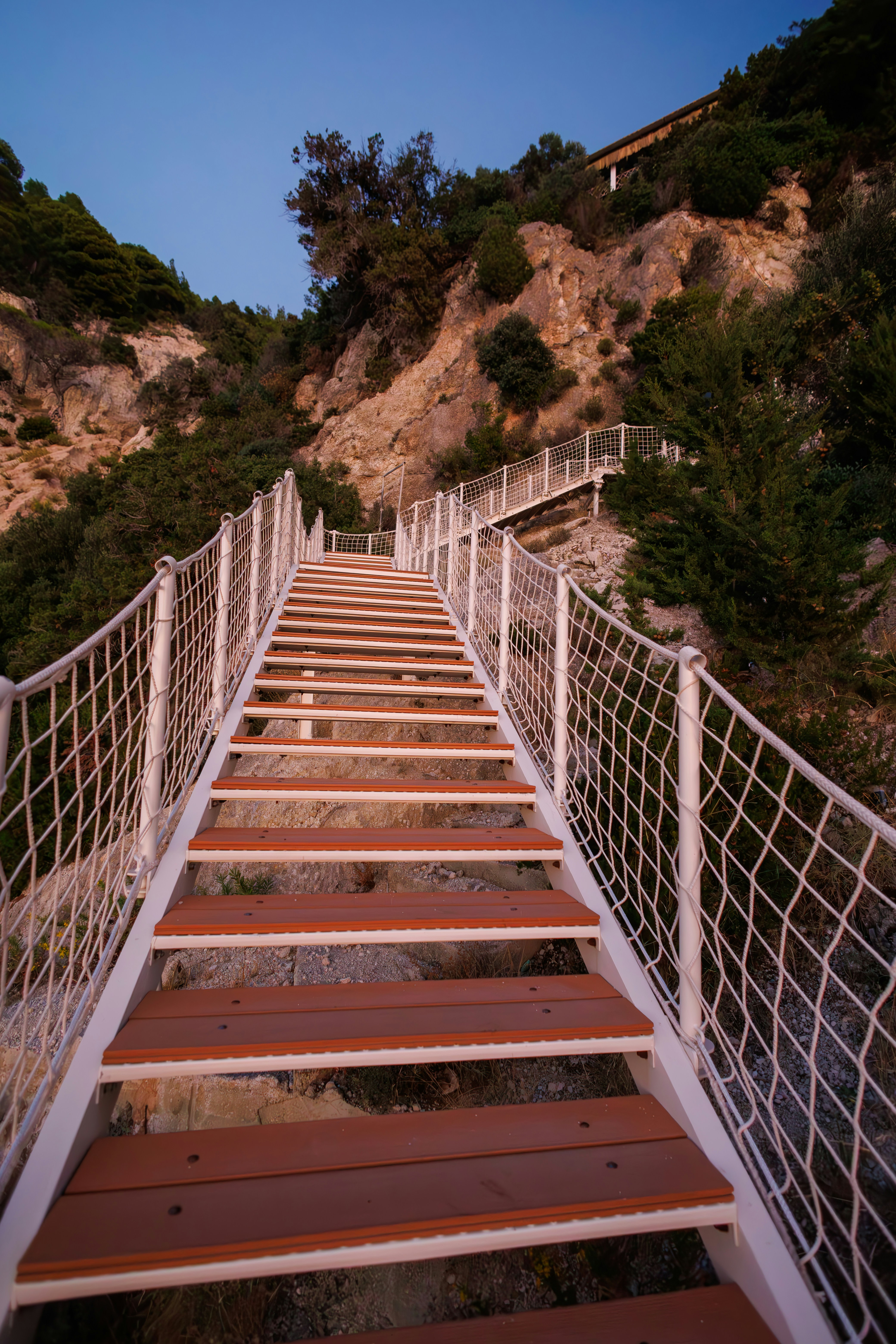 A set of stairs leading up to the top of a hill photo – Free ...