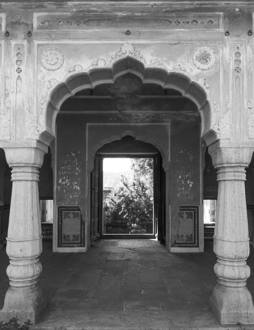 a black and white photo of an archway