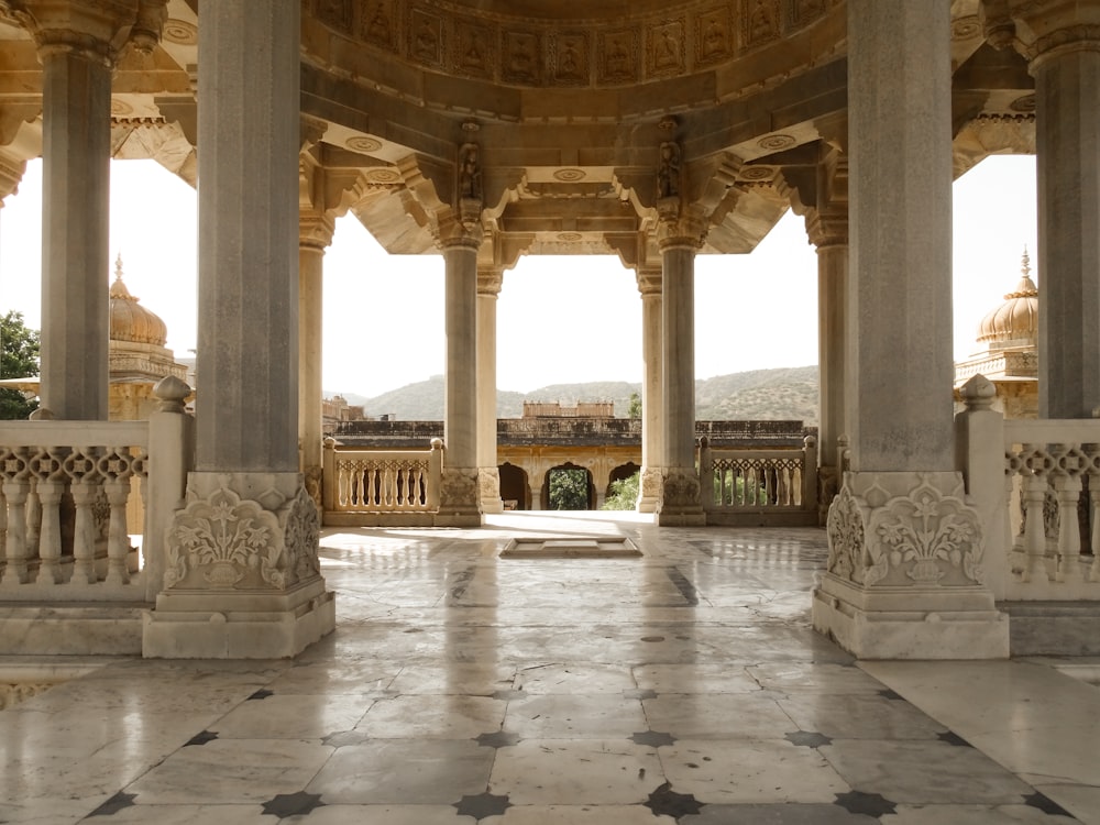 a large room with columns and a tiled floor