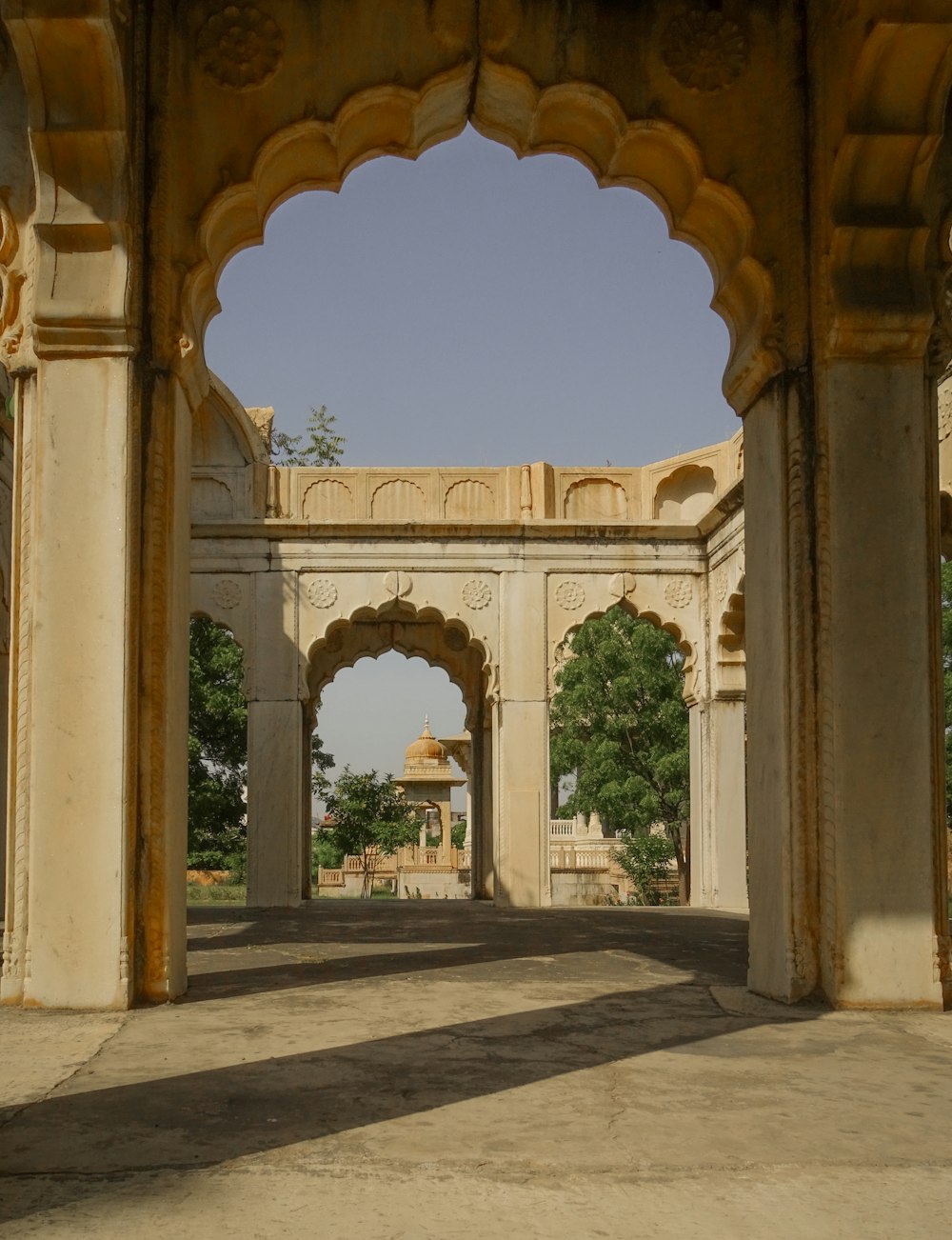 a stone archway with a clock tower in the background