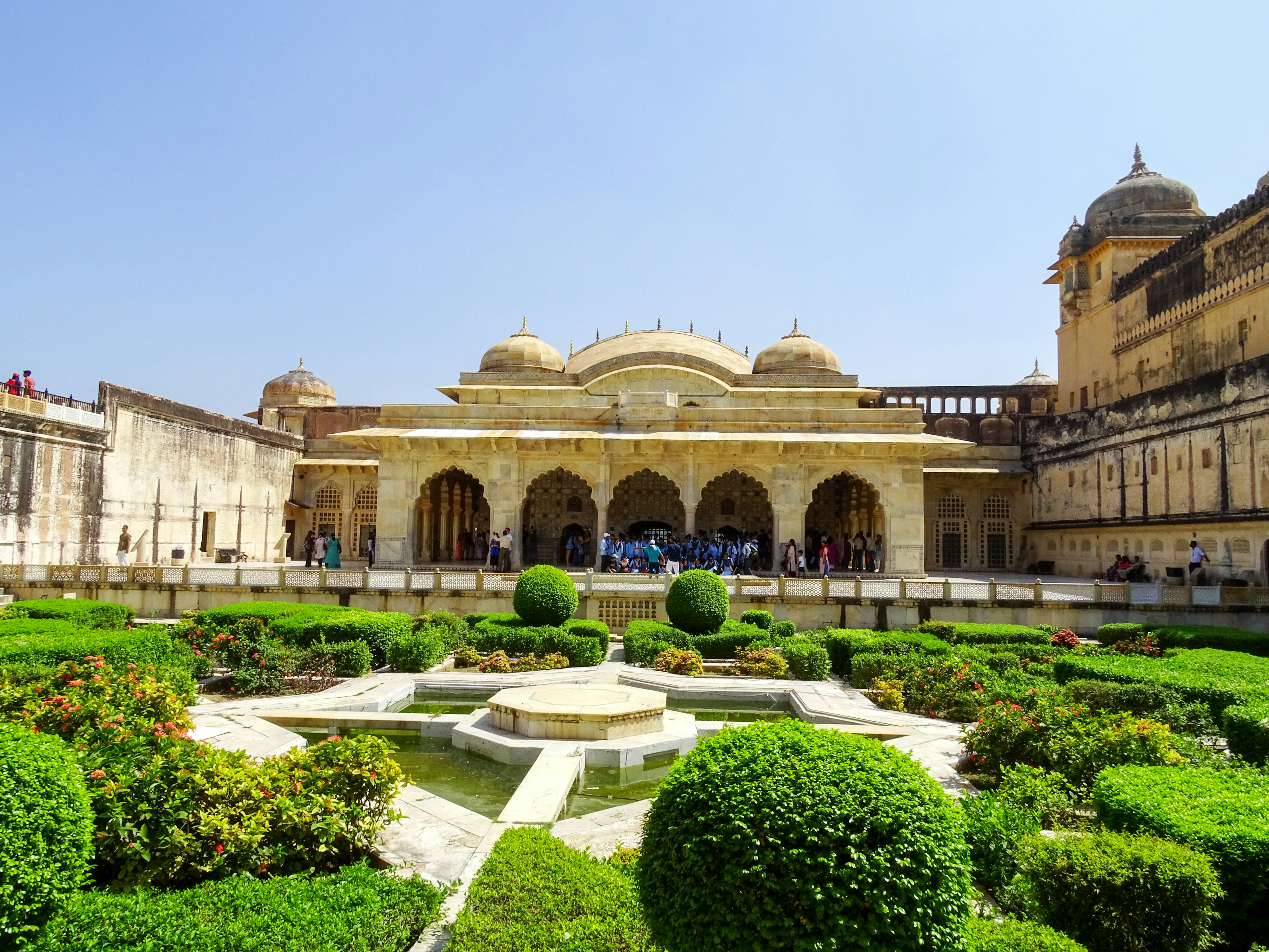 a large building with a fountain in the middle of it