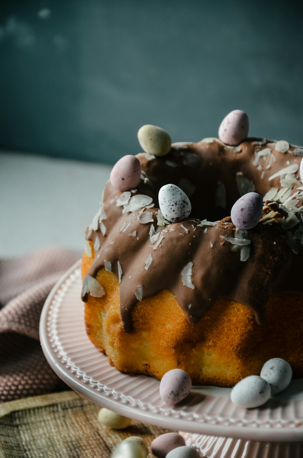 a bundt cake with chocolate frosting and mini eggs