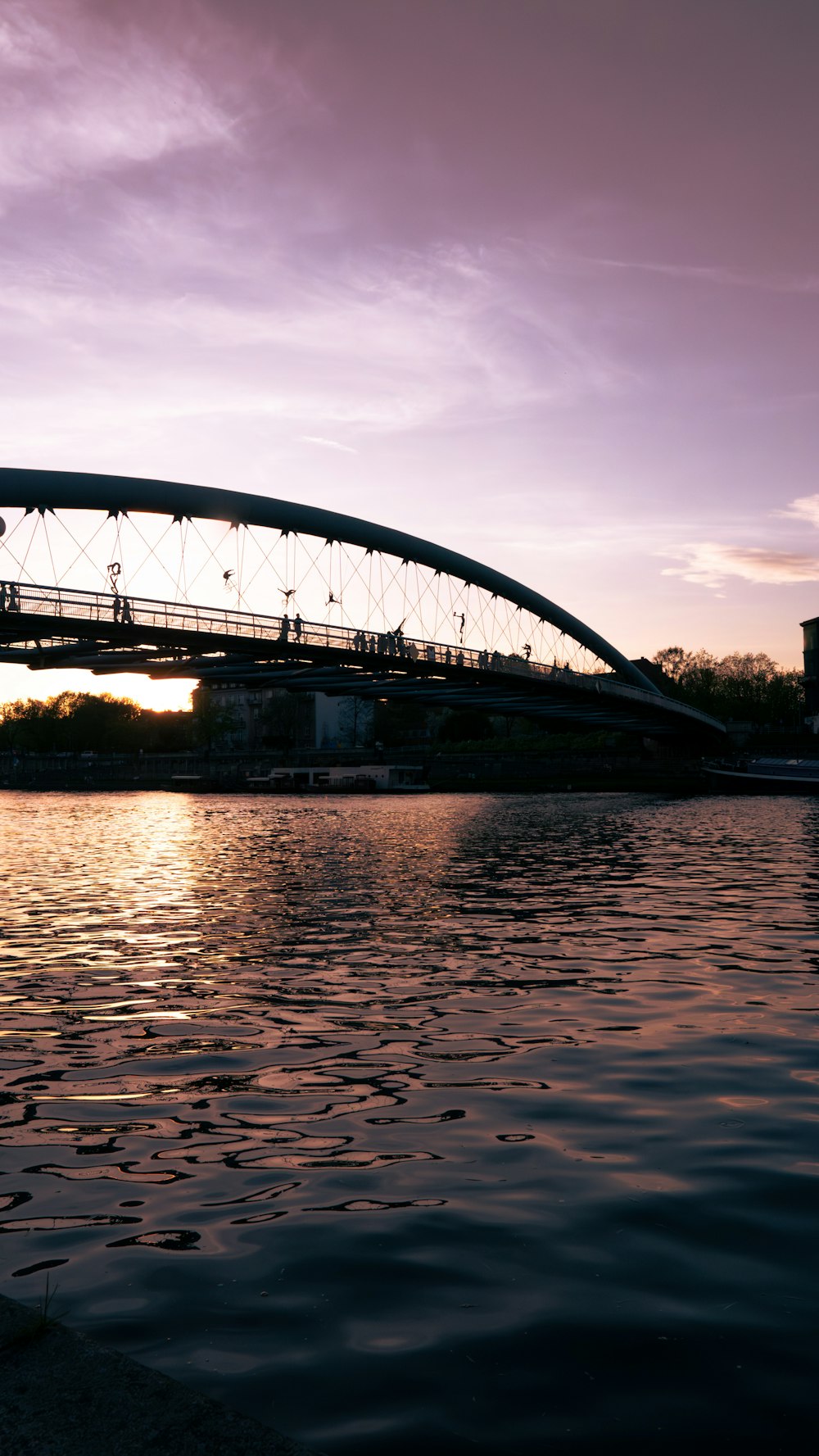 a bridge over a body of water at sunset