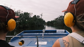 a couple of people on a boat with headphones