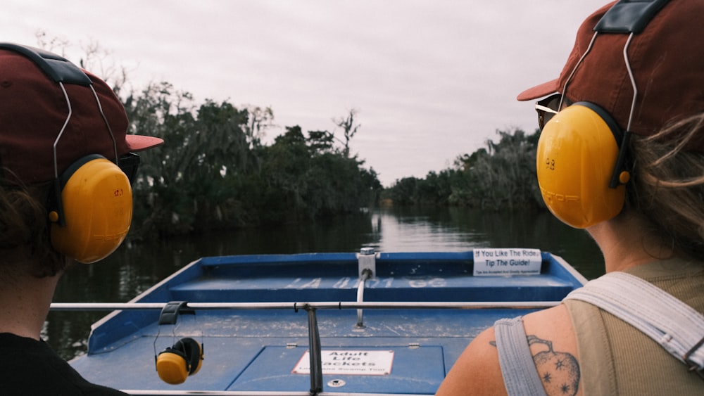 a couple of people on a boat with headphones