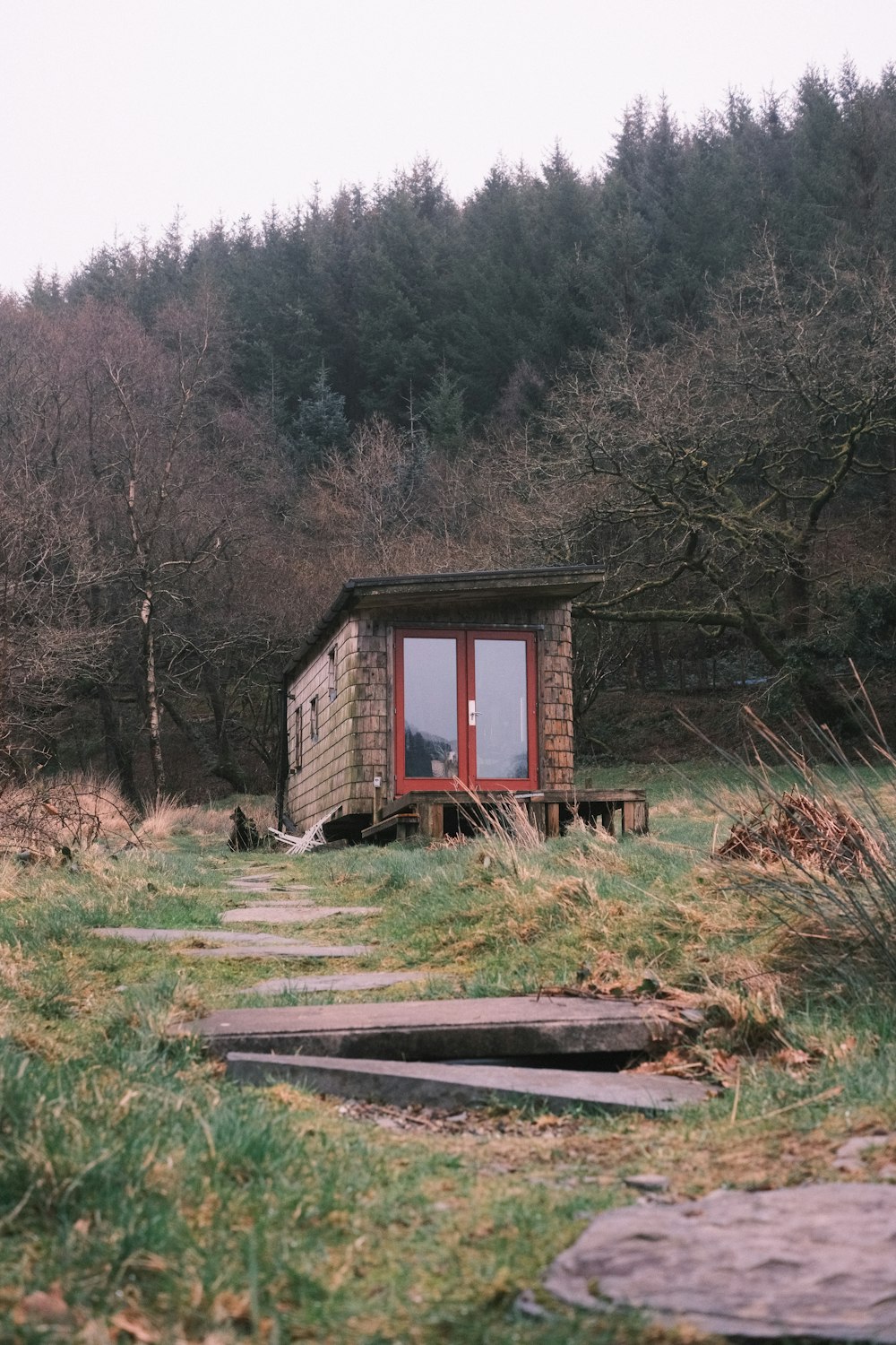 a small cabin in the middle of a field