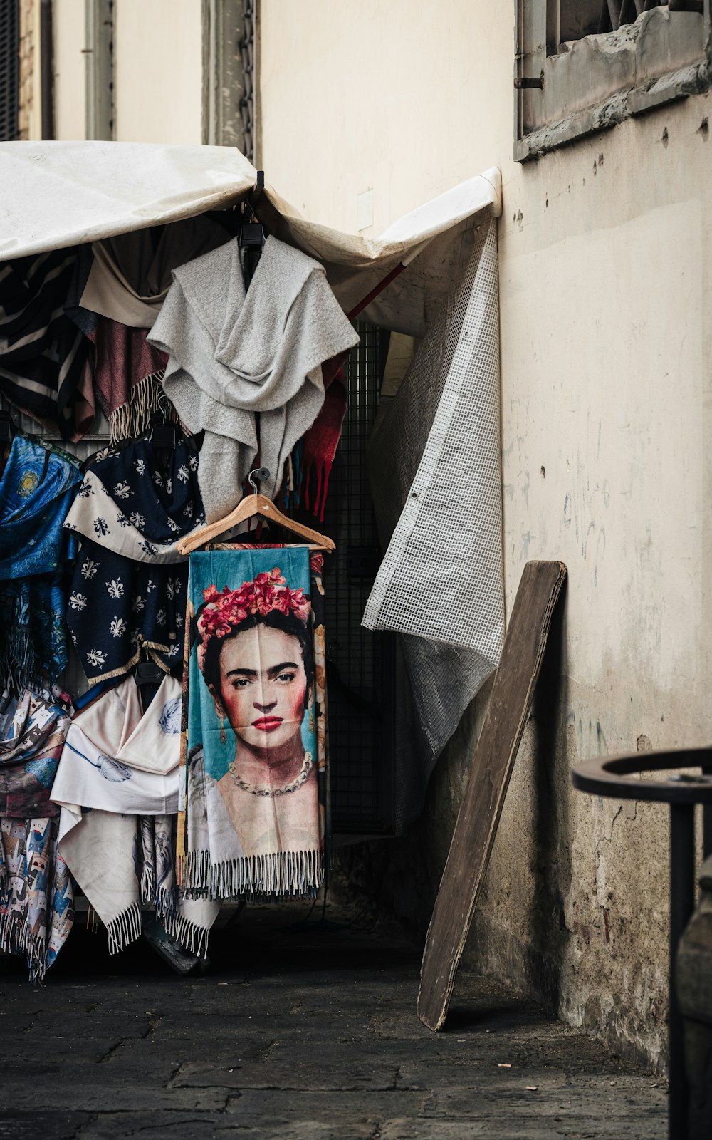 a picture of a woman's face is hanging on a clothes rack