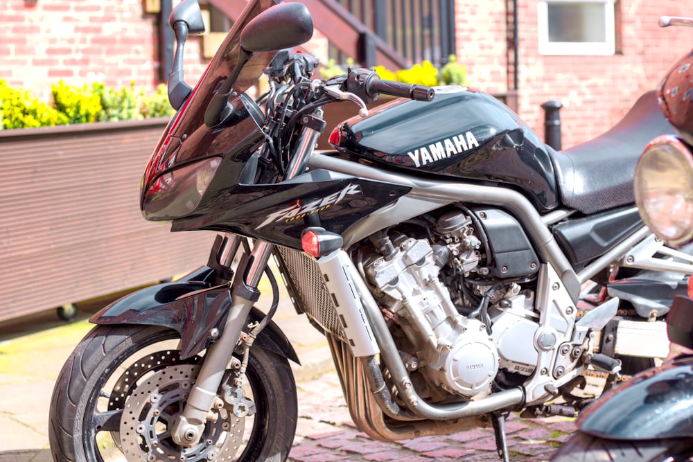 a yamaha motorcycle parked on a brick sidewalk