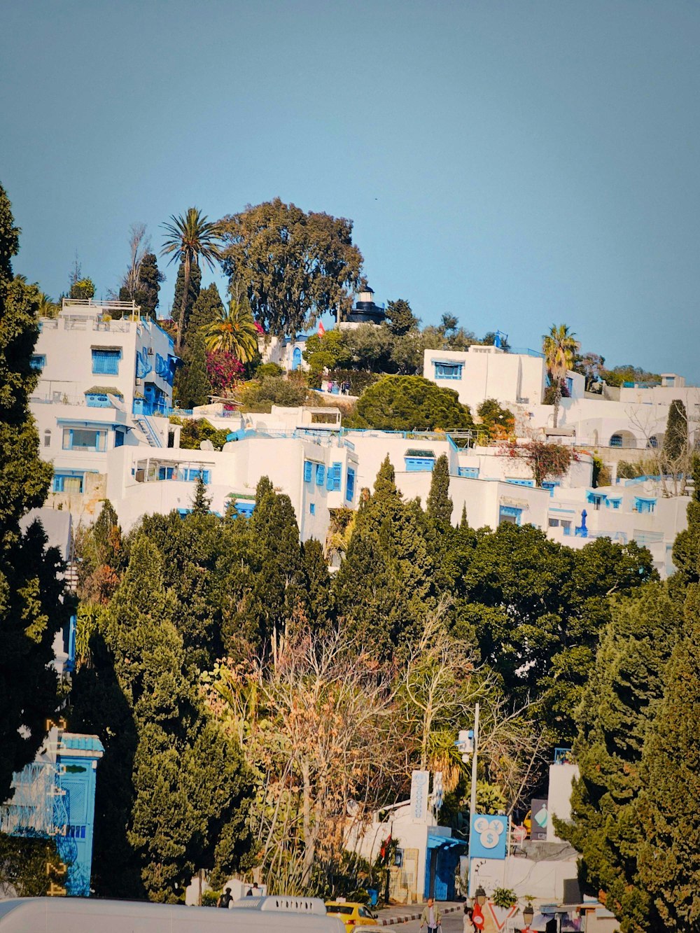 a white building with blue balconies on top of it