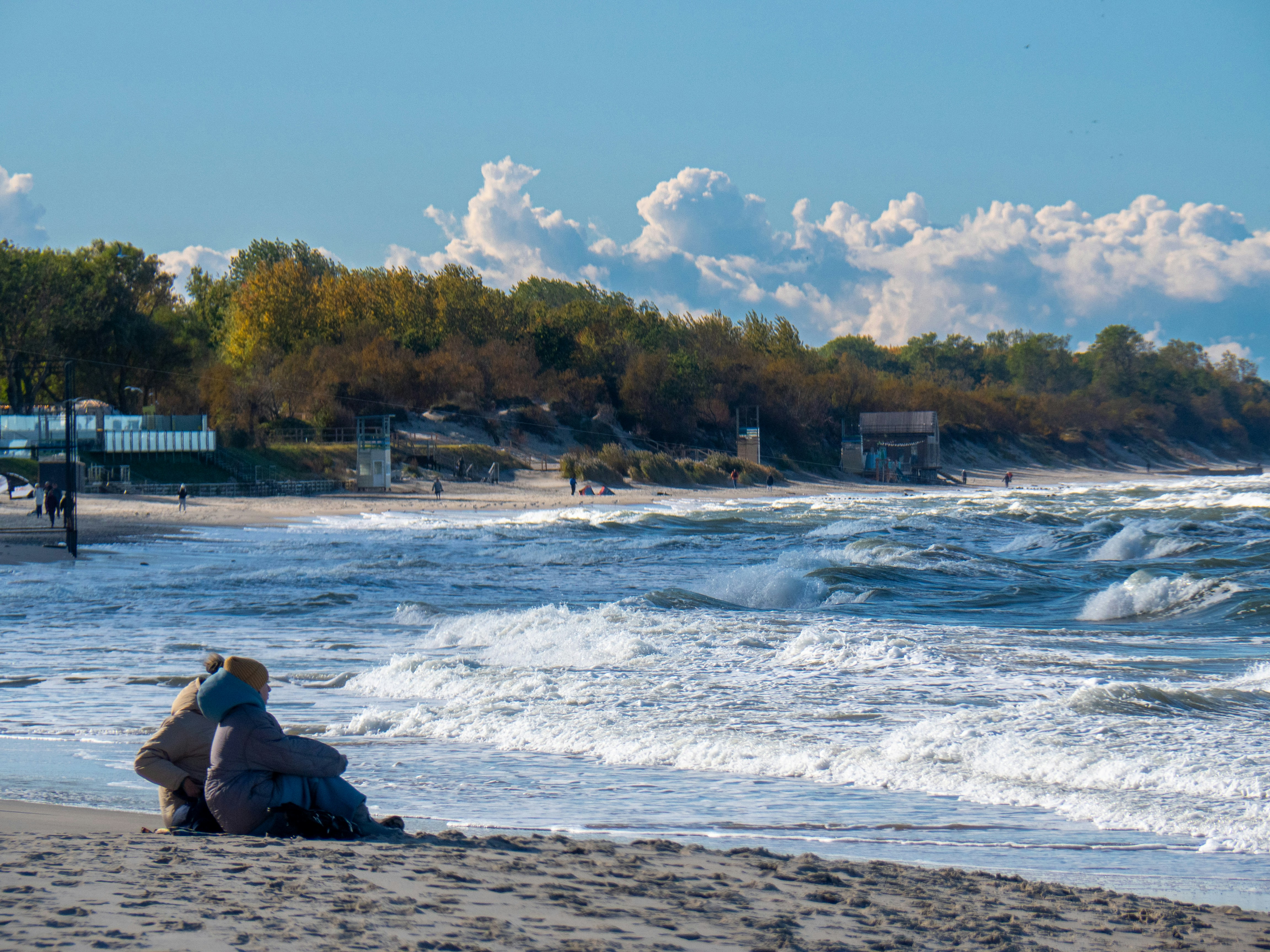 a person sitting on a beach next to the ocean