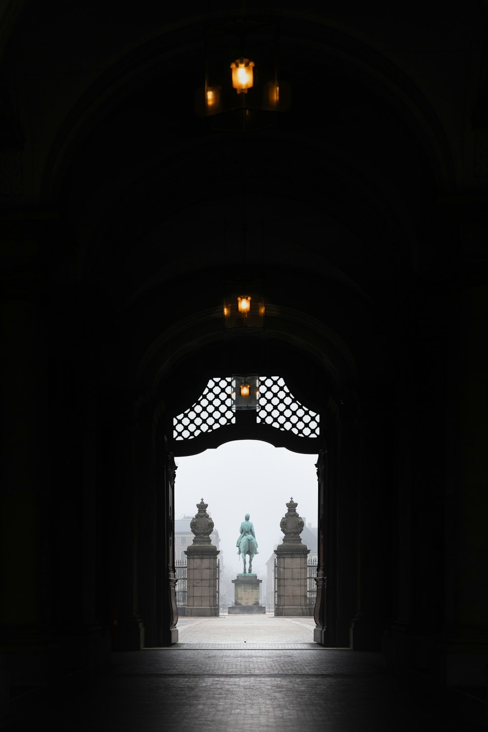 an open doorway with a statue in the distance