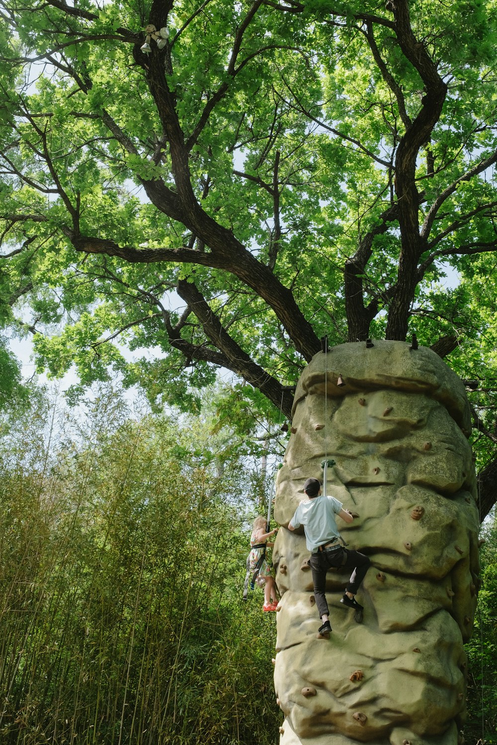 a man climbing up the side of a rock wall