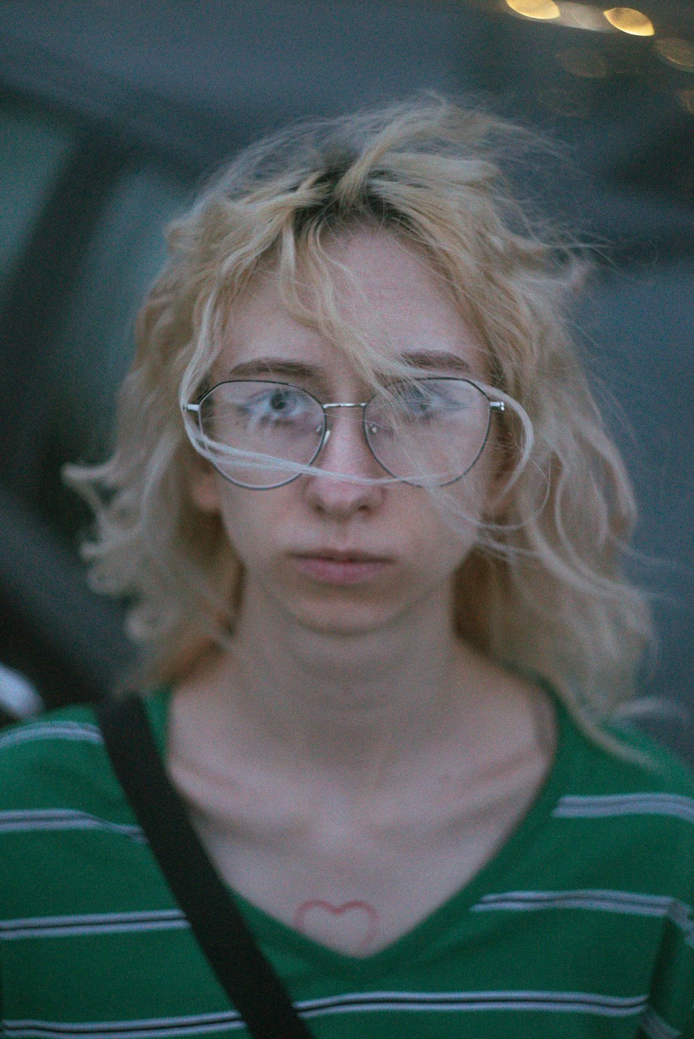 a woman wearing glasses and a green shirt