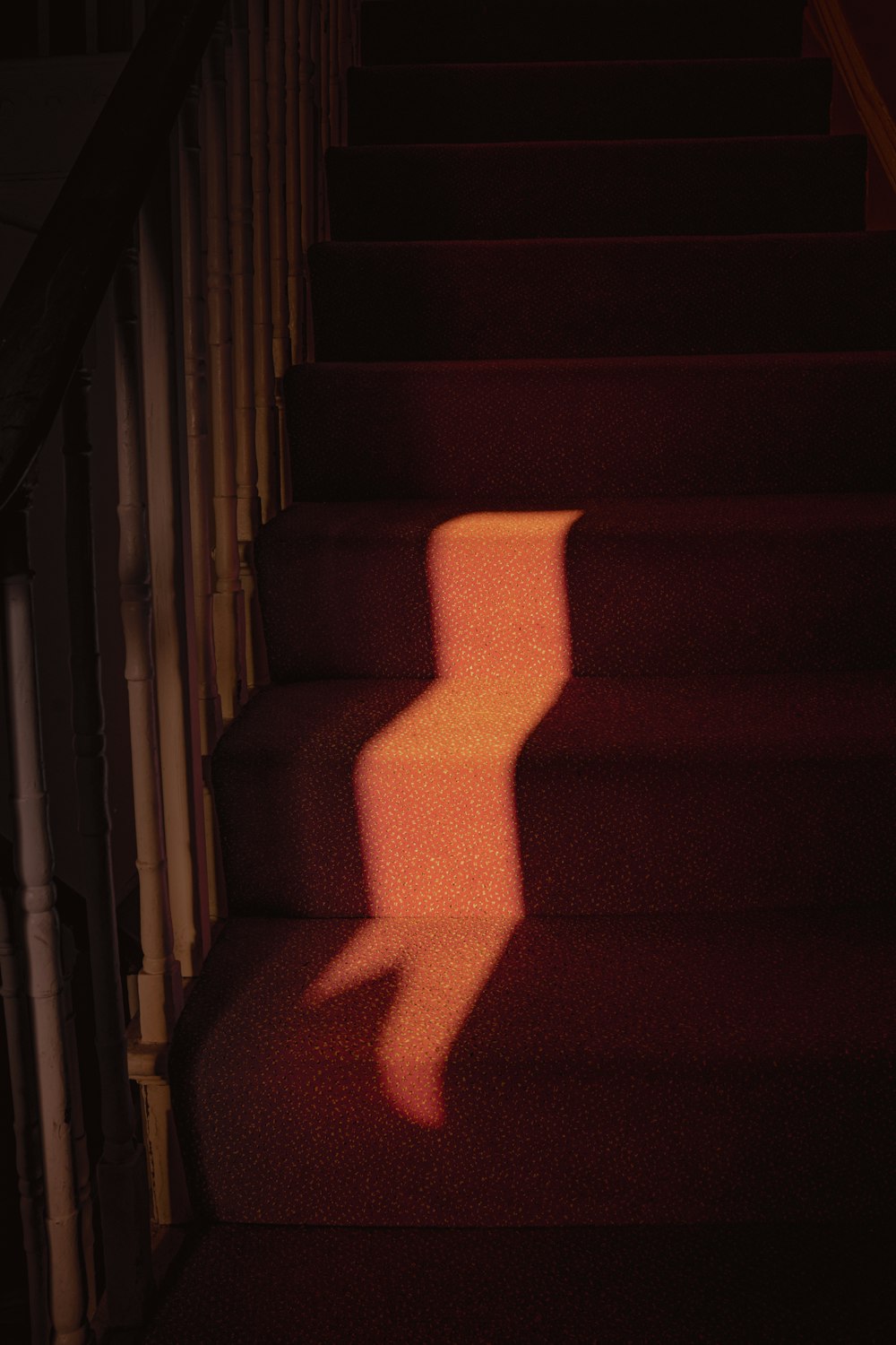 a shadow of a chair on a staircase