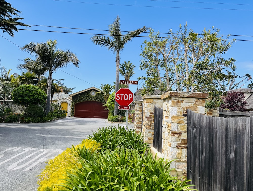 a red stop sign sitting on the side of a road