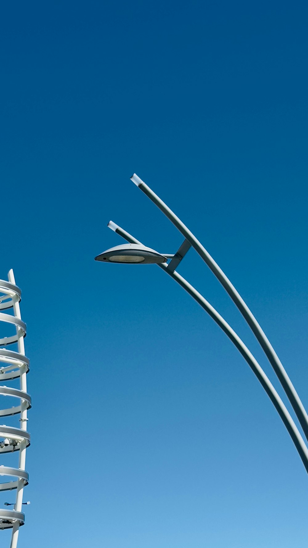 a street light and a street light pole against a blue sky