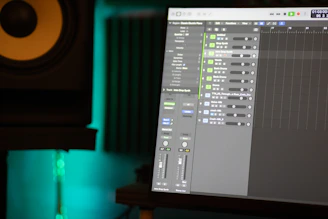 a computer screen with a sound board in the background